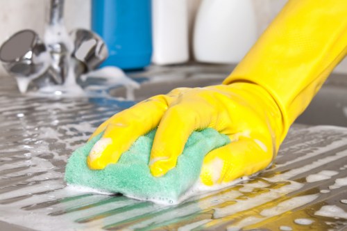 Domestic cleaner tidying a modern flat in W8